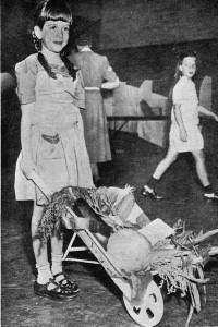 Featured in the August 19, 1943 Winnetka Talk is Joan Lois Davis at the WCH-sponsored Victory Garden Show with the prize-winning wheelbarrow of vegetables.