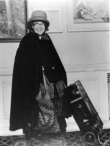 Anita publicity shot with suitcase and cape